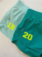 Customisable turquoise green recycled fibre shorts, ideal for school sports teams, running clubs, and personalised activewear.