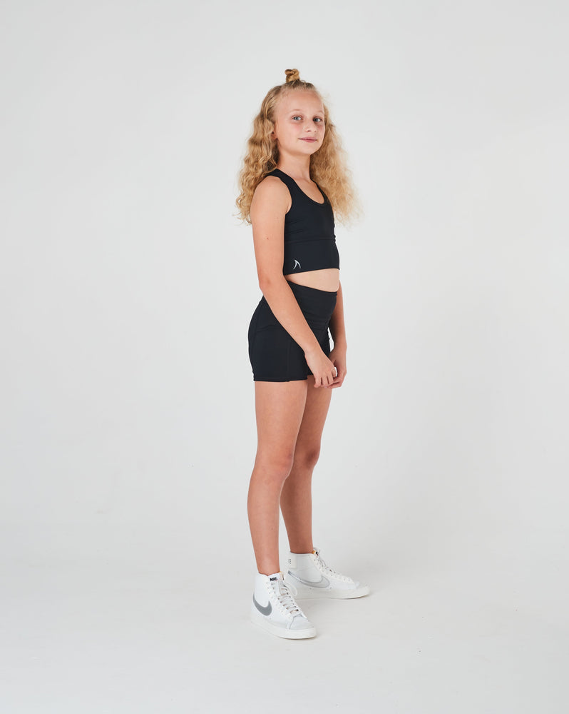 Black bike pants for girls with a high-waisted fit and side pockets, perfect for dance, athletics, netball, and school sports.