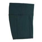 Forest green bike shorts worn under a school uniform, ideal for layering under dresses, skirts, and netball uniforms for extra coverage and comfort.